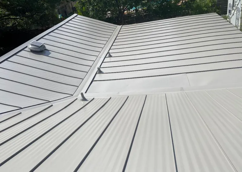 Solar attic fan installed on a metal roof for Roof Ventilation in Raleigh